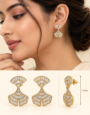 Gold-tone fan-shaped hanging earrings with sparkling clear baguette-cut stones and intricate detailing.