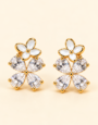Gold-tone floral stud earrings with white enamel flowers and sparkling clear crystal petals.