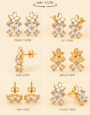 Gold-tone floral stud earrings with white enamel flowers and sparkling clear crystal petals .
