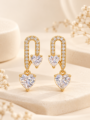 Gold-tone heart drop earrings with sparkling clear stones, featuring a crystal-studded U-shaped design and two heart-shaped gems.
